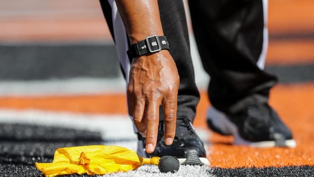 Oct 23, 2022; Cincinnati, Ohio, USA; Line judge Terry Brown (43) picks up a penalty flag during the first half in the game between Atlanta Falcons and Cincinnati Bengals at Paycor Stadium.