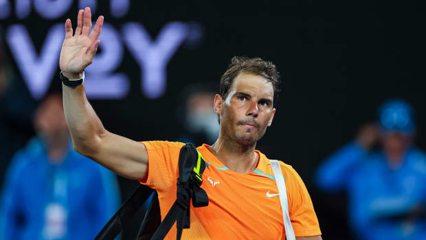 Rafael Nadal waves to fans after being upset at the 2023 Australian Open.
