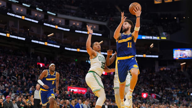 Dec 10, 2022; San Francisco, California, USA; Golden State Warriors guard Klay Thompson (11) makes a layup against Boston Celtics forward Grant Williams (12) in the fourth quarter at the Chase Center.