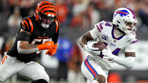 Buffalo Bills wide receiver Stefon Diggs (14) turns towndield after completing a catch as Cincinnati Bengals linebacker Logan Wilson (55) defends in the first quarter of a Week 17 NFL game, Monday, Jan. 2, 2023, at Paycor Stadium in Cincinnati.