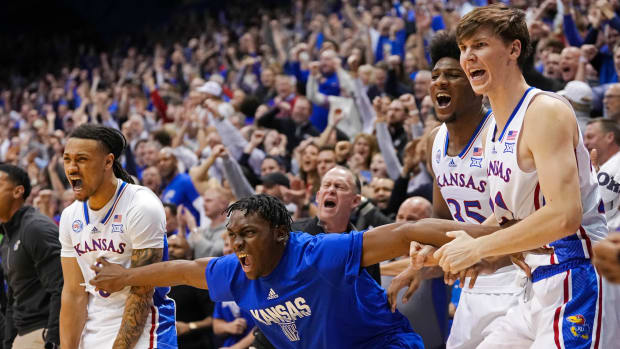 The Kansas Jayhawks bench celebrates during the second half against the Oklahoma Sooners.