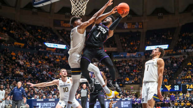 Jan 18, 2023; Morgantown, West Virginia, USA; TCU Horned Frogs guard Mike Miles Jr. (1) shoots against West Virginia Mountaineers forward Mohamed Wague (11) during the first half at WVU Coliseum.