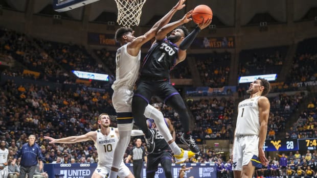 Jan 18, 2023; Morgantown, West Virginia, USA; TCU Horned Frogs guard Mike Miles Jr. (1) shoots against West Virginia Mountaineers forward Mohamed Wague (11) during the first half at WVU Coliseum