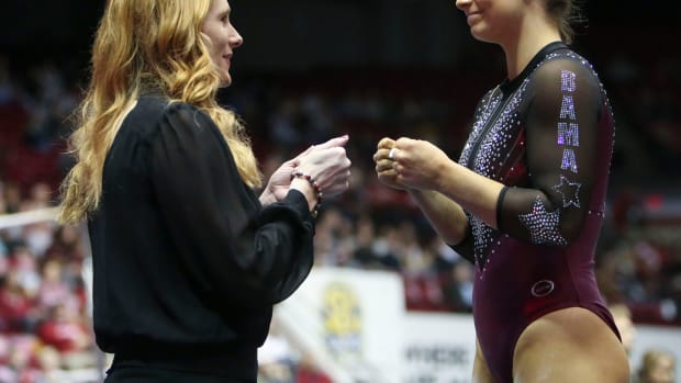 Alabama head coach Ashley Johnston encourages Alabama gymnast Lilly Hudson before her turn on the floor during the meet with Florida Friday in Coleman Coliseum. Gymnastics Alabama Vs Florida