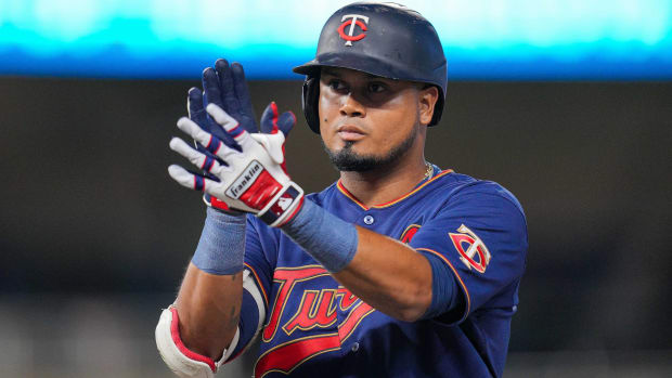 Twins infielder Luis Arráez claps his hands while on second base during a game.
