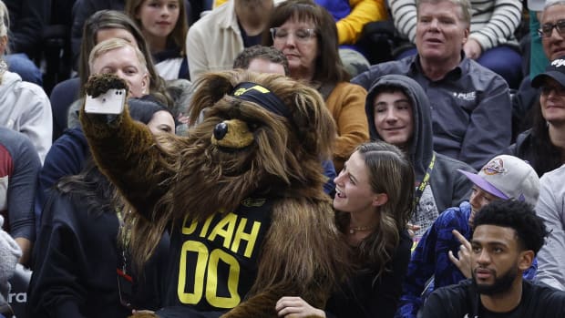 The Utah Jazz Bear takes selfies with fans in the second half against the Minnesota Timberwolves at Vivint Arena.