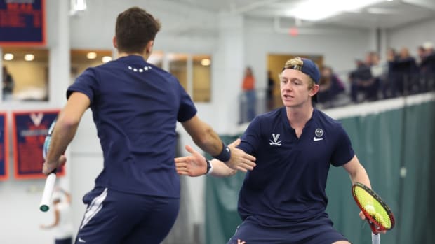 Alexander Kiefer and Jeffrey von der Schulenburg celebrate after winning a point in doubles play during the Virginia men's tennis match against UNC-Wilmington at Boar's Head Sports Club.