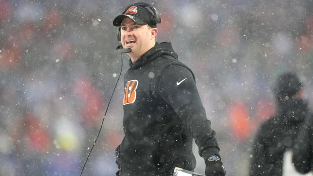Bengals coach Zac Taylor looks toward the scoreboard in the second quarter during an NFL divisional playoff football game between the Bengals and the Bills.