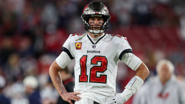 Buccaneers quarterback Tom Brady (12) stands with his hands on his hips before a wild card game against the Cowboys.