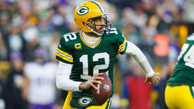 Packers QB Aaron Rodgers rolls out to pass vs. the Vikings.