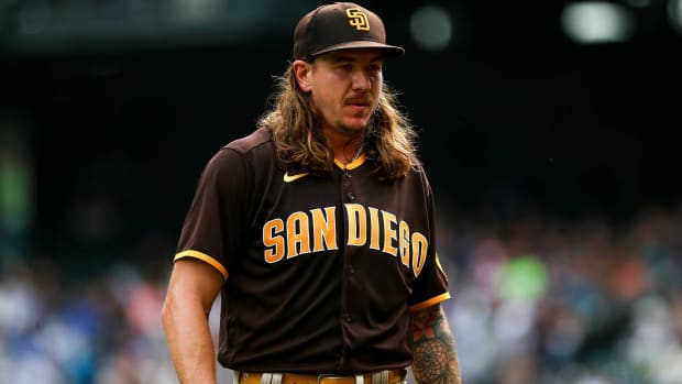 Padres pitcher Mike Clevinger walks off the field after pitching in a game.