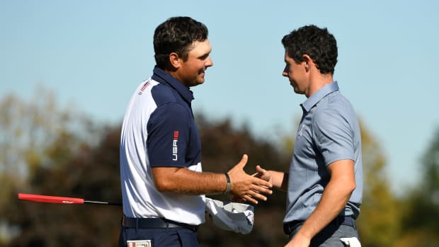 Patrick Reed of the United States and Rory McIlroy of Northern Ireland shake hands after their match during the single matches in 41st Ryder Cup Hazeltine National Golf Club.