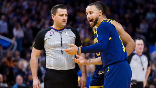 Golden State Warriors guard Stephen Curry (30) argues with official Matt Boland after being ejected for throwing his mouth guard during the second half against the Memphis Grizzlies at Chase Center.