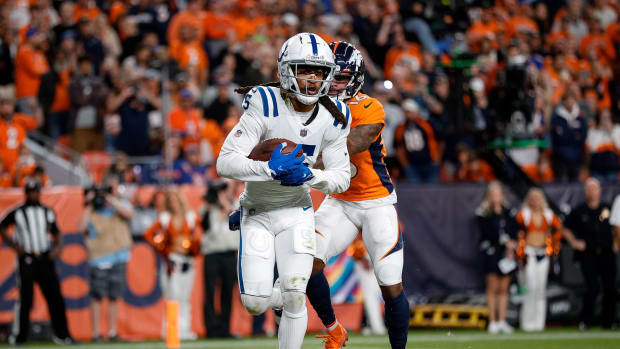 Oct 6, 2022; Denver, Colorado, USA; Indianapolis Colts cornerback Stephon Gilmore (5) intercepts a pass intended for Denver Broncos wide receiver Tyrie Cleveland (16) in the fourth quarter at Empower Field at Mile High.