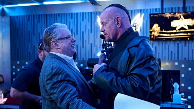 The Undertaker talks with Bruce Prichard backstage at WrestleMania