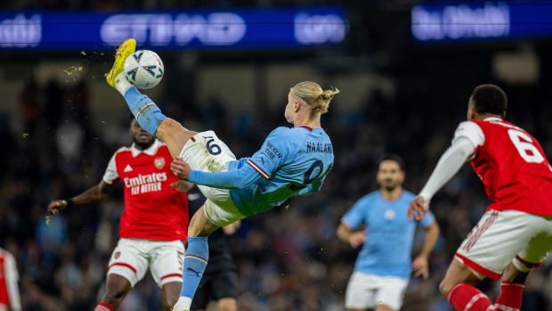 Erling Haaland pictured shooting with an overhead kick during an FA Cup game between Manchester City and Arsenal in 2023