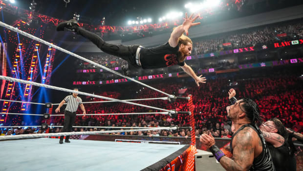 Sami Zayn dives over the top rope on Raw