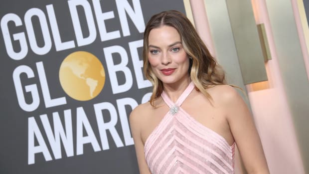 Actress Margot Robbie smiles for the cameras at the Golden Globe Awards.
