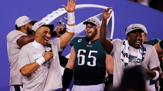 Philadelphia Eagles quarterback Jalen Hurts, left, offensive tackle Lane Johnson (65) and teammates react after the NFC Championship NFL football game between the Philadelphia Eagles and the San Francisco 49ers on Sunday, Jan. 29, 2023, in Philadelphia. The Eagles won 31-7. (AP Photo/Seth Wenig)