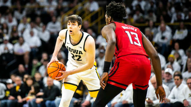 Iowa forward Patrick McCaffery (22) dribbles as Rutgers forward Antwone Woolfolk (13) defends during a NCAA Big Ten Conference men’s basketball game, Sunday, Jan. 29, 2023, at Carver-Hawkeye Arena in Iowa City, Iowa. Syndication Hawkcentral