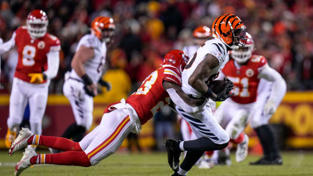 Cincinnati Bengals wide receiver Tee Higgins (85) fights a tackle by Kansas City Chiefs cornerback Joshua Williams (23) in the second quarter of the AFC championship NFL game between the Cincinnati Bengals and the Kansas City Chiefs, Sunday, Jan. 29, 2023, at Arrowhead Stadium in Kansas City, Mo. The Chiefs led 13-6 at halftime. Cincinnati Bengals At Kansas City Chiefs Afc Championship Jan 29 098