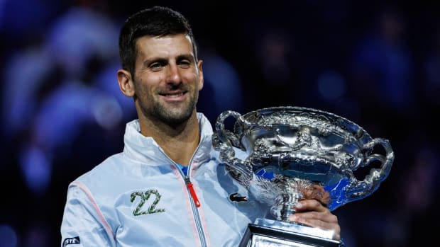 Novak Djokovic holds the 2023 Australian Open trophy after winning the tournament.