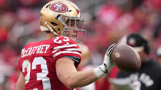 49ers running back Christian McCaffrey catches a ball in warmups before a game.