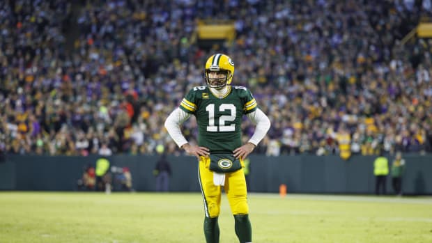Green Bay Packers QB Aaron Rodgers standing on field