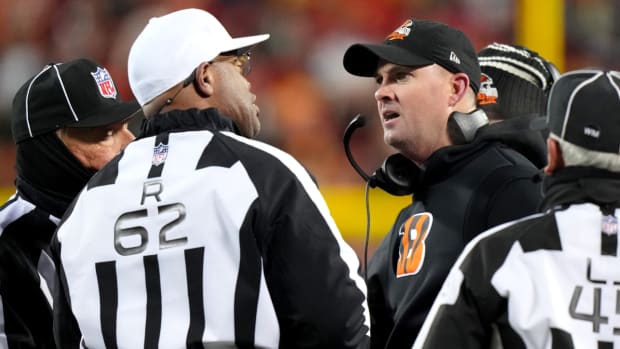 Referee Ron Torbert speaks with Bengals coach Zac Taylor on the sidelines about a play.