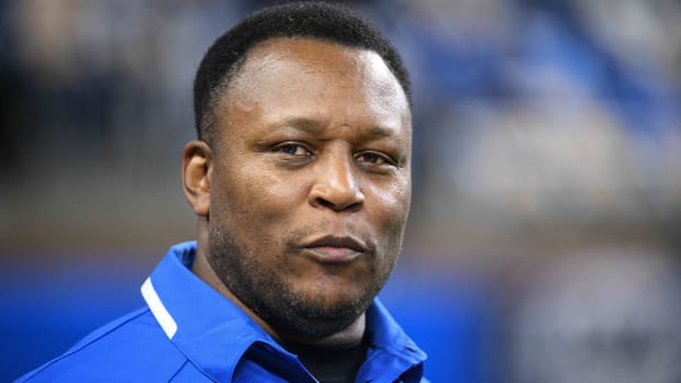 Former Lions running back Barry Sanders looks on while on the sidelines of a game.