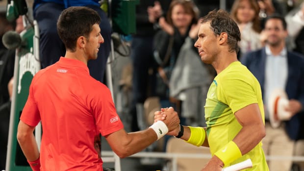 Novak Djokovic and Rafael Nadal shake hands after their match at the 2022 French Open.