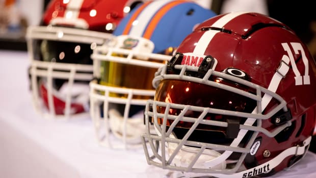 Helmets from the University of Georgia, Unversity of Florida and University of Alabama are set out on the table in front of St. John Paul II Catholic High School's Terrion Arnold before he announces his signing on National Signing Day Wednesday, Feb. 3, 2021.