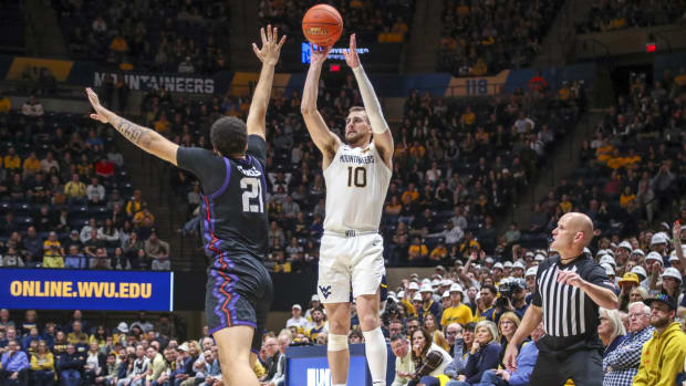 Jan 18, 2023; Morgantown, West Virginia, USA; West Virginia Mountaineers guard Erik Stevenson (10) shoots a three pointer during the second half against the TCU Horned Frogs at WVU Coliseum.