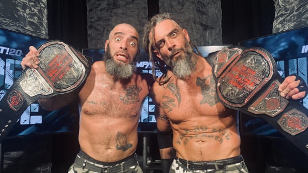 Mark and Jay Briscoe pose with the Impact tag team championships