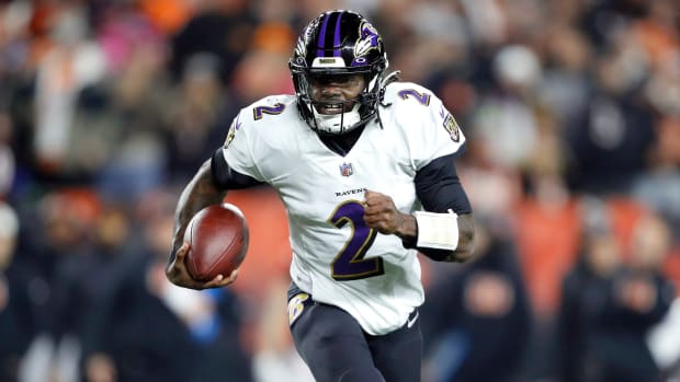 Ravens quarterback Tyler Huntley (2) runs with the ball during the first half of a wild card game against the Bengals.