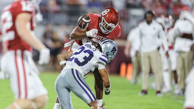 Oklahoma's Brayden Willis (9) fumbles the ball after being hit by Kansas State's Julius Brents (23) in the fourth quarter during a college football game between the University of Oklahoma Sooners (OU) and the Kansas State Wildcats at Gaylord Family - Oklahoma Memorial Stadium in Norman, Okla., Saturday, Sept. 24, 2022. Kasnas State won 41-34.