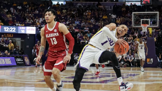 LSU Tigers guard Xavier Pinson (1) is fouled by Alabama Crimson Tide guard Jahvon Quinerly (13) during the first half at the Pete Maravich Assembly Center.
