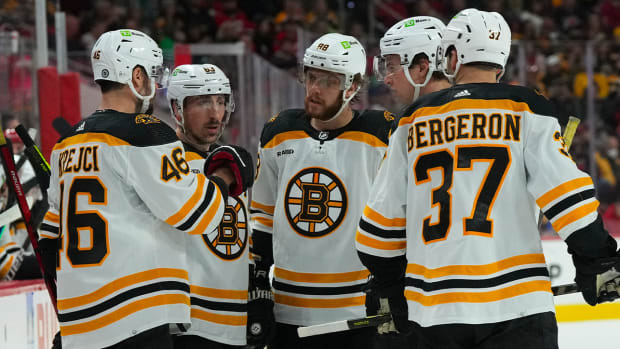 Jan 29, 2023; Raleigh, North Carolina, USA; Boston Bruins center David Krejci (46) left wing Brad Marchand (63) right wing David Pastrnak (88) defenseman Charlie McAvoy (73) and center Patrice Bergeron (37) talk against the Carolina Hurricanes during the second period at PNC Arena.