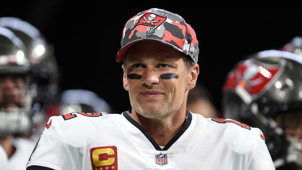 Buccaneers quarterback Tom Brady (12) smiles during warmups before a game.