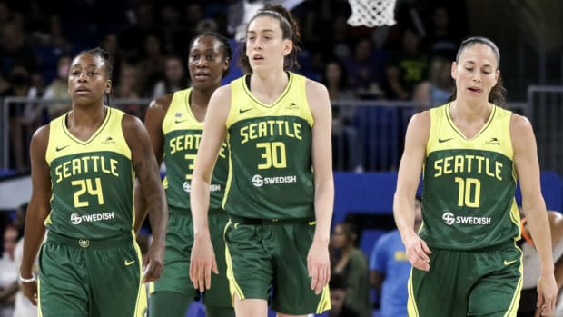 Jewell Loyd, Breanna Stewart and Sue Bird walk back to the bench during the Storm’s game against the Sky.