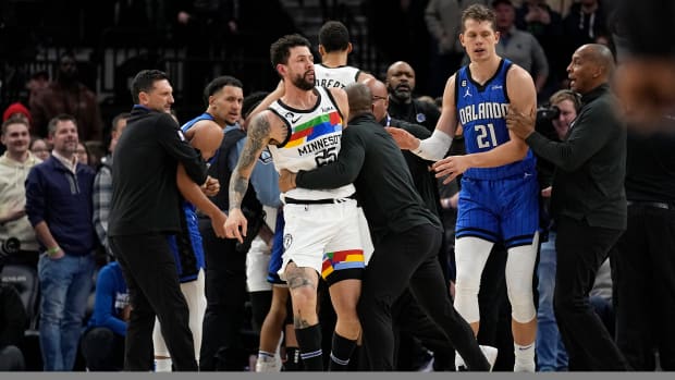 Timberwolves guard Austin Rivers is pulled away from the scrum as players fought.