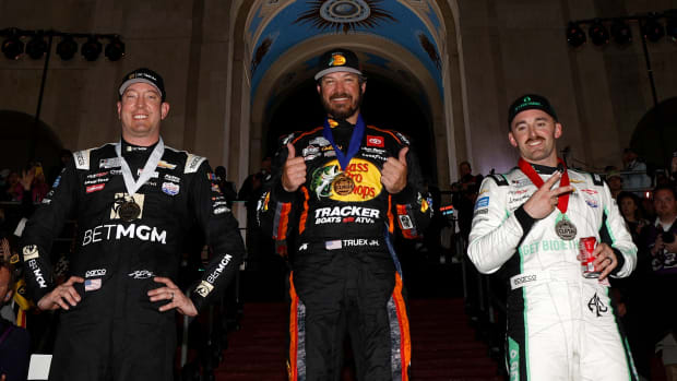 Martin Truex Jr., winning driver of the #19 Bass Pro Shops Toyota (center); Austin Dillon, second-place finishing driver of the #3 Get Bioethanol Chevrolet (right); and Kyle Busch, driver of the third-place finishing #8 BetMGM Chevrolet, pose on the podium after finishing 1-2-3 in Sunday's Busch Light Clash at the Los Angeles Memorial Coliseum. (Photo by Chris Graythen/Getty Images)