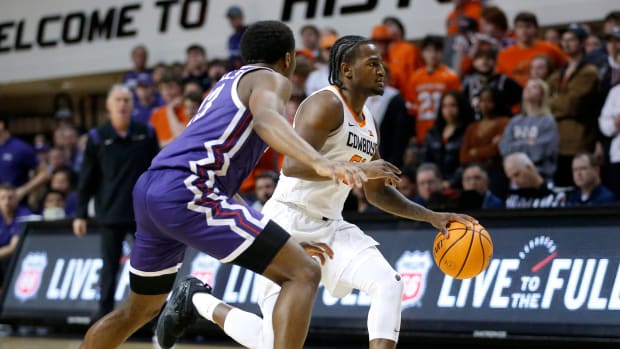 Oklahoma State's John-Michael Wright (51) dribbles up court at TCU's Shahada Wells (13) defends in the second half during the men's college basketball game between the Oklahoma State Cowboys and TCU Horned Frogs at Gallagher-IBA Arena in Stillwater, Okla., Saturday, Feb.4, 2023.