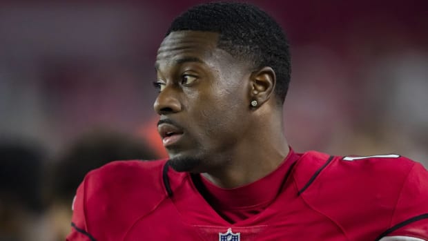 Cardinals wide receiver A.J. Green looks on during a game without a helmet.