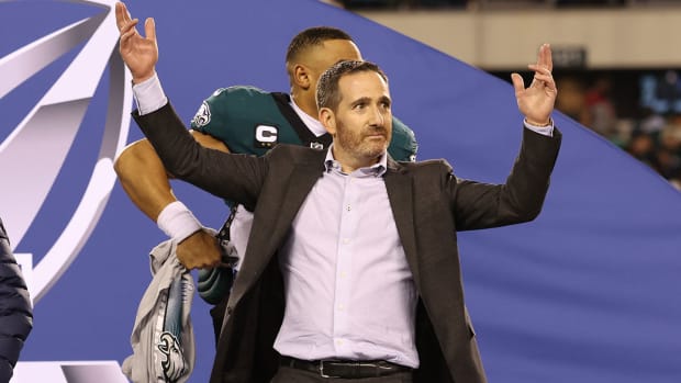 Howie Roseman raises his hands on stage after the Eagles win the NFC championship.