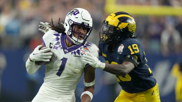 Dec 31, 2022; Glendale, Arizona, USA; TCU Horned Frogs wide receiver Quentin Johnston (1) is defended by Michigan Wolverines defensive back Rod Moore (19) in the second half of the 2022 Fiesta Bowl at State Farm Stadium.