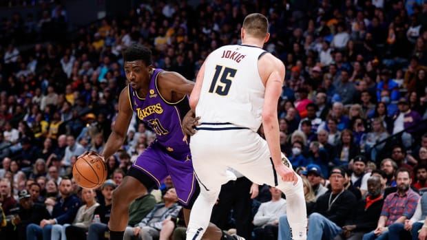 Lakers forward Thomas Bryant drives on Nuggets star Nikola Jokić.