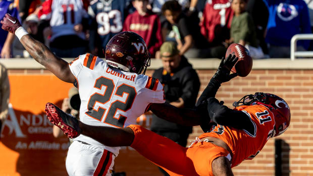 Feb 4, 2023; Mobile, AL, USA; American defensive back Chamarri Conner of Virginia Tech (22) breaks up a pass to National wide receiver Tre Tucker of Cincinnati (11) in the end zone during the second half of the Senior Bowl college football game at Hancock Whitney Stadium. Mandatory Credit: Vasha Hunt-USA TODAY Sports