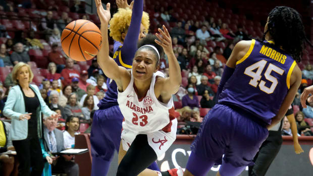 Alabama guard Brittany Davis (23) loses the ball as she tries to wedge her way between LSU guard Jasmine Carson (2) and LSU guard Alexis Morris (45) in Coleman Coliseum Monday night.