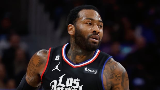 Former Clippers guard John Wall dribbles the ball down the court.